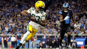 Green Bay Packers wide receiver Savion Williams (83) runs up field in front of Detroit Lions cornerback Ennis Rakestraw Jr. (2) after catching a pass during the first half of an NFL football game, Sunday, Oct. 25, 2026, in Detroit. (Rey Del Rio/AP Photo)
