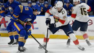 Buffalo Sabres centre Peyton Krebs, left, challenges for the puck against Florida Panthers centre Eetu Luostarinen during the first period of an NHL hockey game Monday, Oct. 12, 2026, in Buffalo, N.Y. (Adrian Kraus/AP Photo)