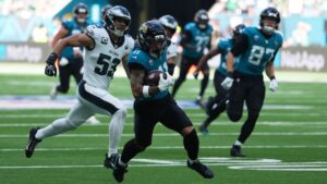 Jacksonville Jaguars wide receiver Parker Washington (11) runs the ball in for a touchdown during an NFL football game against the Philadelphia Eagles in London, Sunday, Oct. 11, 2026. (Dave Shopland/AP Content Services for the NFL)
