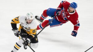 Pittsburgh Penguins' Sidney Crosby (87) skates past Montreal Canadiens' Mike Matheson (8) during third period NHL hockey action in Montreal, Thursday, Dec. 12, 2024. (Christinne Muschi/CP)
