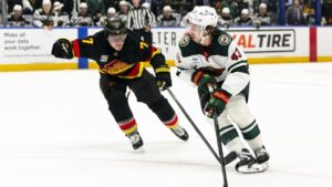 Minnesota Wild's Quinn Hughes (43) skates past Vancouver Canucks' Brendan Gallagher (7) during the second period of an NHL game in Vancouver on Sunday, Oct. 25, 2026. (Jacob Mallari/CP)