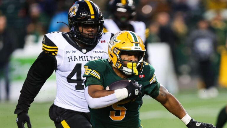 Edmonton Elks' Justin Rankin (5) is chased by Hamilton Tiger-Cats' Philip Ossai (46) during second half CFL football action in Edmonton on Saturday, September 26, 2026. (Codie McLachlan/THE CANADIAN PRESS)