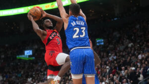 Toronto Raptors' Immanuel Quickley (5) shoots past Orlando Magic's Tristan da Silva (23) during first half NBA basketball action in Toronto on Wednesday, Oct. 28, 2026. (Nathan Denette/CP)