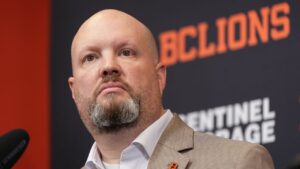 B.C. Lions general manager Ryan Rigmaiden listens during a news conference where new head coach Buck Pierce, not seen, was introduced at the CFL football team's practice facility, in Surrey, B.C., Wednesday, Dec. 4, 2024. (Darryl Dyck/CP)