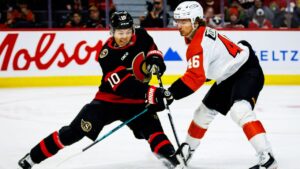 Ottawa Senators' Jordan Spence (10) clears the puck under pressure from Philadelphia Flyers' Trevor Zegras (46) during first period NHL action in Ottawa, on Thursday, Oct. 8, 2026. (Keito Newman/THE CANADIAN PRESS)