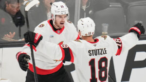 Ottawa Senators' Drake Batherson, left, is congratulated by Tim Stutzle (18) after scoring against Boston Bruins' Jeremy Swayman during the second period of an NHL hockey game, Monday, Oct. 5, 2026, in Boston. (Charles Krupa/AP)