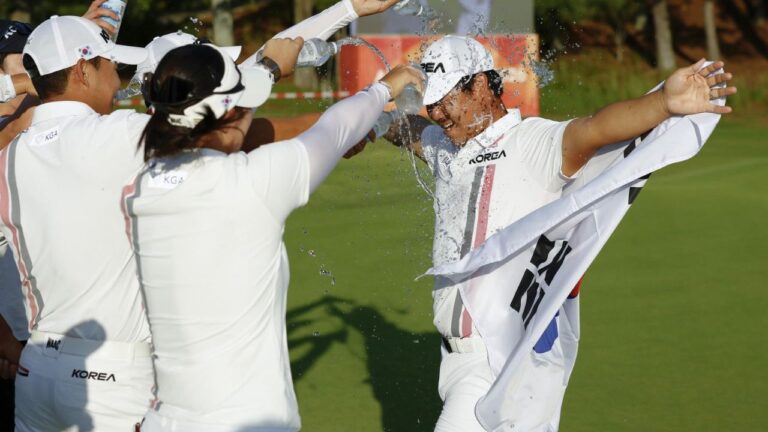 South Korea's Tom Kim, right, also known as Kim Joo-hyung, celebrates after winning the men’s singles in golf at the Asian Games in Kasugai, central Japan, Saturday, Oct. 3, 2026. (Natsumi Yasumoto/Kyodo News via AP)