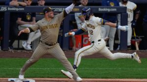 Milwaukee Brewers' Sal Frelick is out at first with San Diego Padres' Ty France covering during the third inning of Game 2 of a National League Divisional baseball playoff series Sunday, Oct. 4, 2026, in Milwaukee. (Chris Carlson/AP)
