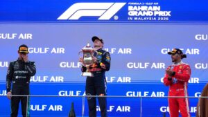 Red Bull driver Max Verstappen of the Netherlands celebrates on the podium flanked by second place Mercedes driver Andrea Kimi Antonelli of Italy, left and third place Ferrari driver Lewis Hamilton of Britain after winning the Bahrain Grand Prix in Sepang, Malaysia, Sunday, Oct. 4, 2026. (Vincent Thian/AP)
